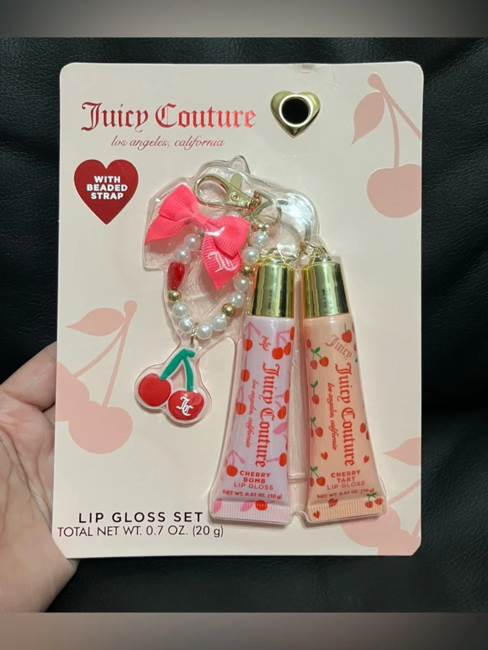 Juicy Couture lip gloss set that includes a beaded cherry keychain